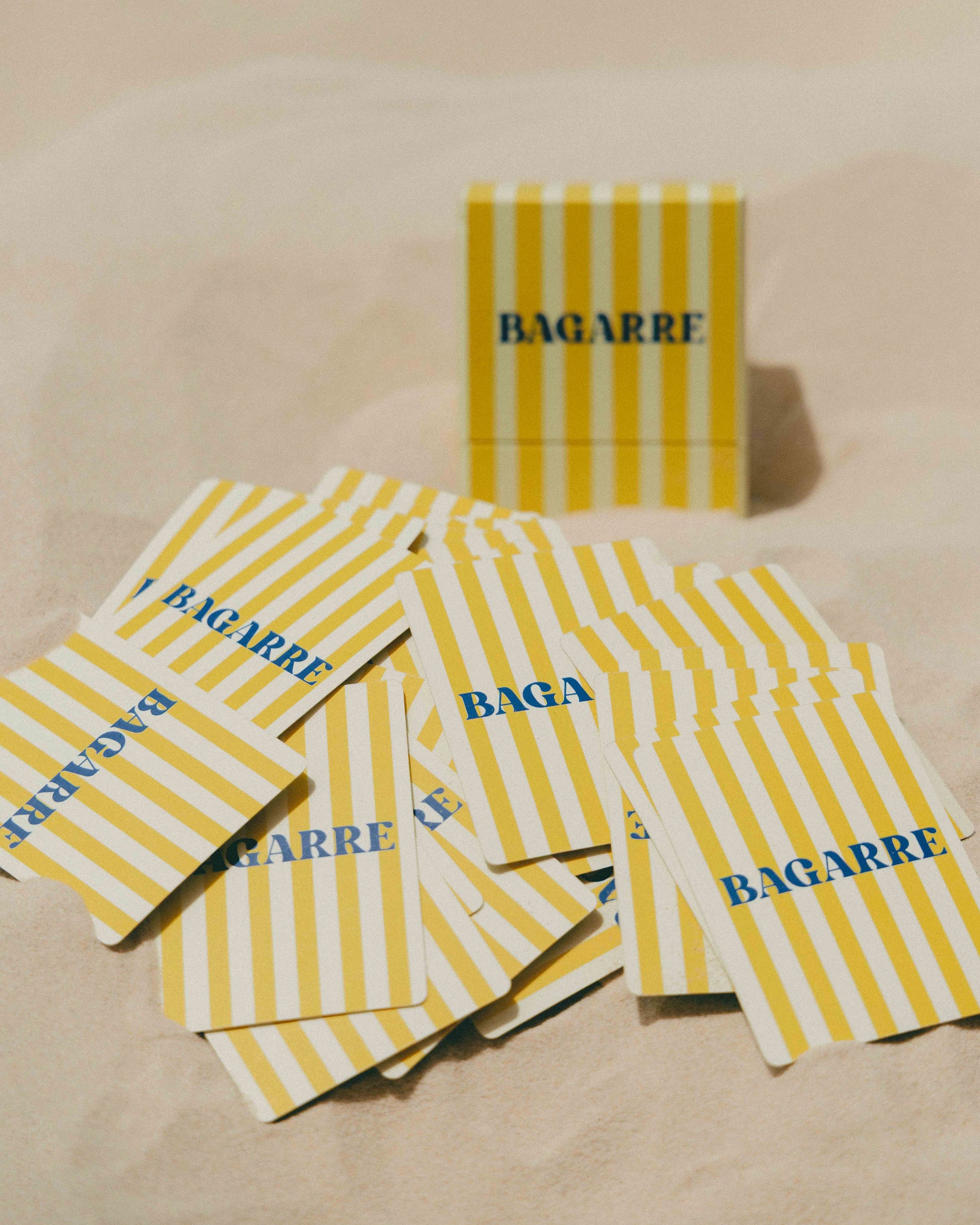 Yellow and white striped packages with 'BAGARRE' branding on a beige surface