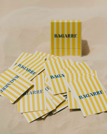 Yellow and white striped packages with 'BAGARRE' branding on a beige surface