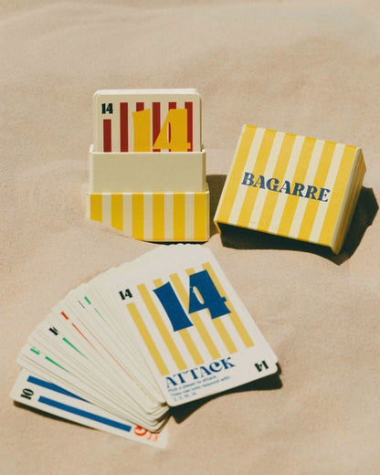Playing cards with yellow and blue design on a beige surface